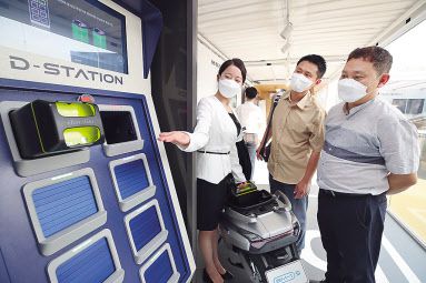 ‘2021 서울 스마트 모빌리티 엑스포(SSME 2021)’의 KT 전시관에서 방문객이 배터리 교환 플랫폼(BSS)을 체험하고 있다. [KT 제공]