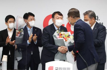 윤석열 대선 예비후보가 30일 오후 서울 여의도 국민의힘 중앙당 당사를 방문, 대외협력위원장인 권영세 의원에게 입당원서를 제출한 뒤 환영 꽃다발을 받고 있다.(사진=연합뉴스)