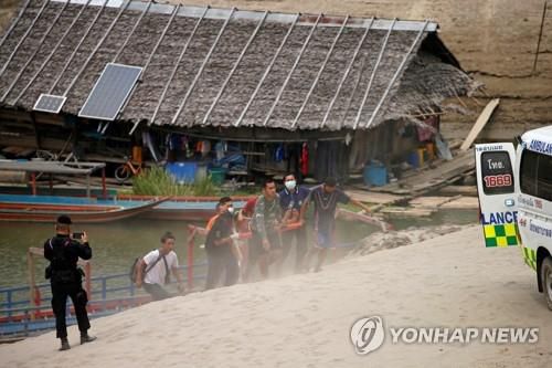 강을 건넌 카렌족 부상자가 구급차로 옮겨지는 모습. 2021.3.30[로이터=연합뉴스]