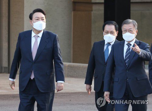 문재인 대통령과 윤석열 대통령 당선인이 3월 28일 오후  만찬 회동을 위해 청와대 상춘재로 향하며 대화하고  있다. [연합뉴스 자료사진]