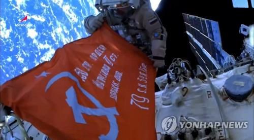 옛 소련군 '승리 깃발' 펼쳐 든 러시아 우주비행사(러시아 연방우주공사/타스=연합뉴스) 28일(현지시간) 러시아 연방우주공사(로스코스모스) 소속 우주비행사 올렉 아르테미예프, 데니스 마트베예프 등 2명이 우주 유영 임무 수행 중 2차 세계대전 당시 옛 소련군이 사용한 승리 깃발을 펼쳐 보이고 있다. 사진은 로스코스모스 웹사이트에서 방송된 것을 캡처한 것이다.2022.4.29 photo@yna.co.kr