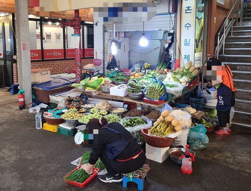 광장시장에서 쪽파를 다듬고 있는 채소가게 사장님 [촬영 홍규빈]