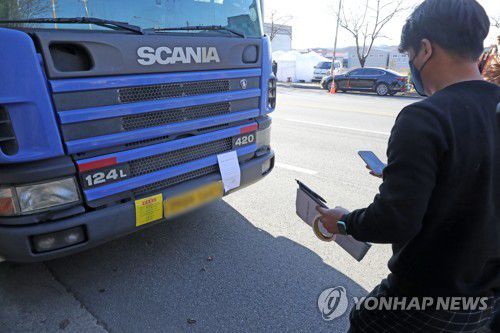 화물연대 조합원 화물차에 조사개시 통지서(포항=연합뉴스) 손대성 기자 = 정부가 8일 철강·석유화학 업종 운송거부자에 대한 업무개시명령을 발동한 가운데 국토교통부와 포항시 관계자가 이날 오후 경북 포항철강산업단지 갓길에 세워진 민주노총 화물연대 소속 조합원의 화물차에 '집단운송 거부행위 조사개시 통지서'와 '단속 예고장'을 붙이고 있다. 2022.12.8 sds123@yna.co.kr