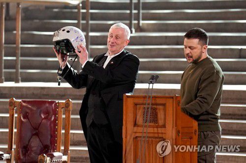 영국 하원의장에게 헬멧 선물한 우크라 대통령(런던 로이터=연합뉴스) 볼로디미르 젤렌스키 우크라이나 대통령이 8일(현지시간) 린지 호일 영국 하원의장에게 우크라이나 조종사의 헬멧을 선물했다. 2023.2.8 photo@yna.co.kr