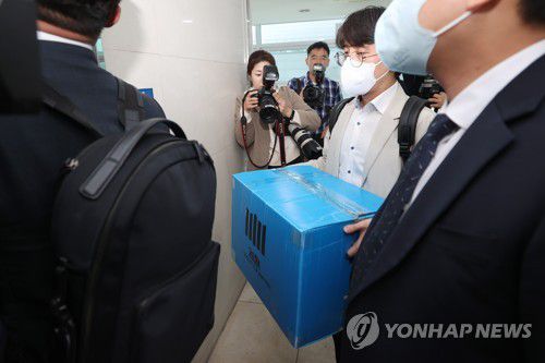 양재식 변호사 사무실 압수수색 마친 검찰(서울=연합뉴스) 신현우 기자 = 검찰이 박영수 전 국정농단 사건 특별검사에 대해 강제수사에 나서며 이른바 '대장동 50억 클럽' 수사를 본격화한 30일 오후 서울 서초구 양재식 변호사 사무실에서 압수수색을 마친 검찰 관계자들이 압수품을 옮기고 있다.     박 전 특검은 우리은행 이사회 의장으로 재직하던 2014년 화천대유자산관리 대주주 김만배 씨 등이 대장동 개발사업 공모를 준비할 때 부국증권 배제 등 컨소시엄 구성을 돕고 프로젝트파이낸싱(PF) 대출을 청탁하는 대가로 50억원을 받기로 한 혐의를 받는다. 양 변호사는 이 과정에서 민간업자와 실무 업무를 담당한 것으로 조사됐다. 2023.3.30 nowwego@yna.co.kr