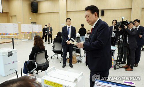 사전투표 용지 받는 윤석열 대통령(부산=연합뉴스) 진성철 기자 = 윤석열 대통령이 제22대 국회의원선거 사전투표가 시작된 5일 부산 강서구 명지1동 행정복지센터 사전투표소에서 선거사무원에게서 사전투표용지를 받고 있다.  2024.4.5  [대통령실통신사진기자단] zjin@yna.co.kr