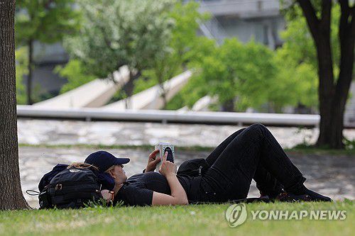 책과 함께 피크닉(서울=연합뉴스) 신현우 기자 = 전국의 낮 기온이 25도 이상으로 올라간 26일 서울 서초구 반포한강공원을 찾은 시민이 그늘에서 책을 읽고 있다. 2024.4.26 nowwego@yna.co.kr