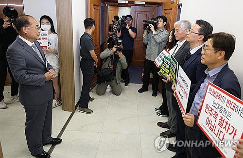 부산대 의대 증원 오늘 결정(부산=연합뉴스) 박성제 기자 = 부결된 부산대 의대 증원을 위한 학칙 개정안을 재심의하는 21일 오후 이 대학 대학본부에서 교무회의실로 향하던 최재원 신임 총장이 피켓 시위를 하는 의대 교수진과 만나고 있다. 2024.5.21 psj19@yna.co.kr