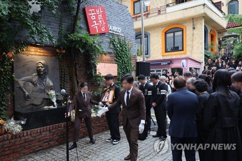 옛 학전 자리한 아르코꿈밭극장 도착한 김민기 영정(서울=연합뉴스) 박동주 기자 = 대학로 소극장의 상징 '학전'을 30여년간 운영하며 후배 예술인을 배출해 온 가수 김민기의 발인식이 엄수된 24일 오전 고인의 영정이 옛 학전이 자리한 서울 종로구 아르코꿈밭극장에 도착하고 있다. 2024.7.24 pdj6635@yna.co.kr