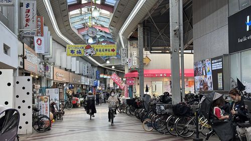 활기 되찾은 후세역 앞 상점가(오사카=연합뉴스) 차대운 기자 = 일본 오사카 외곽 후세역 앞 시장에서 행인들이 자전거를 타고 오가고 있다. 쇠락해가던 상권은 빈집을 개조한 세카이 호텔 입점 이후 다시 활기를 띠고 잇다. 2025.5.16 cha@yna.co.kr (끝)