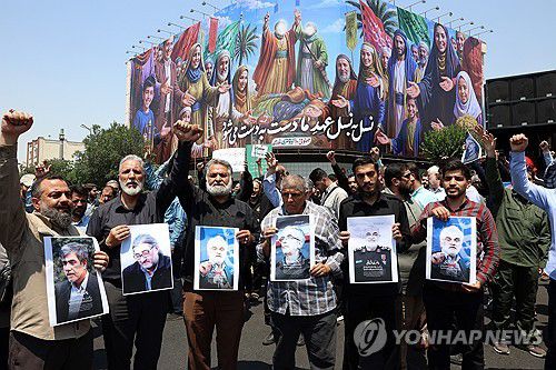 사망한 이란 핵과학자와 군 고위부 사진 들고 있는 시위대(테헤란 EPA=연합뉴스) 13일(현지시간) 이란 수도 테헤란에서 시위대가 이스라엘의 공격을 규탄하는 시위를 벌이고 있다. 2025.06.14