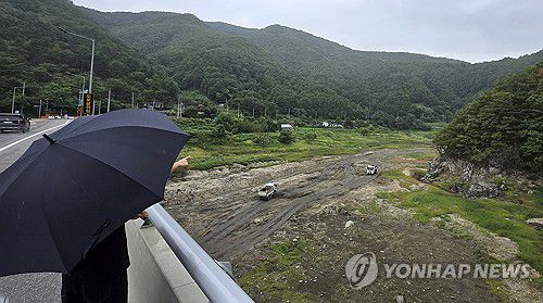 극한 가뭄 강릉에 찔끔 비(강릉=연합뉴스) 유형재 기자 = 4일 강원 강릉시 주요 상수원인 오봉저수지 일원에 비가 내리고 있다.     맨바닥을 드러낸 저수지 상류에서 트럭들이 물길을 내는 작업을 하고 있다. 2025.9.4 yoo21@yna.co.kr