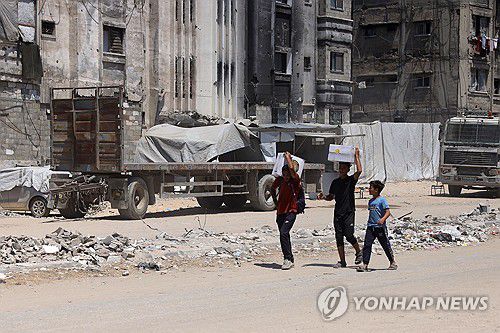 구호품 가지고 이동하는 가자 주민[AFP 연합뉴스 자료사진. 재판매 및 DB 금지]