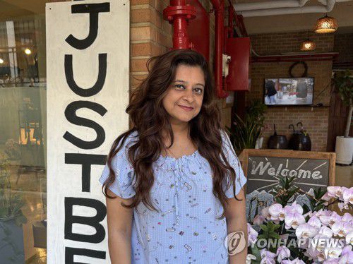 "만족스러워요" 소감 전하는 앤첼라 씨(서울=연합뉴스) 최혜정 인턴기자 = 지난 23일 서대문구 템플스테이 숙소 '홍대선원'에 묵고 있는 앤첼라 씨가 숙소 간판 옆에서 포즈를 취하고 있다. 2025.10.25