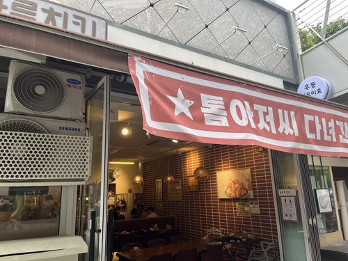 마포의 한 치킨집에 '톰 아저씨 다녀간 집'이라는 현수막이 걸려 있다.[촬영 김윤구]