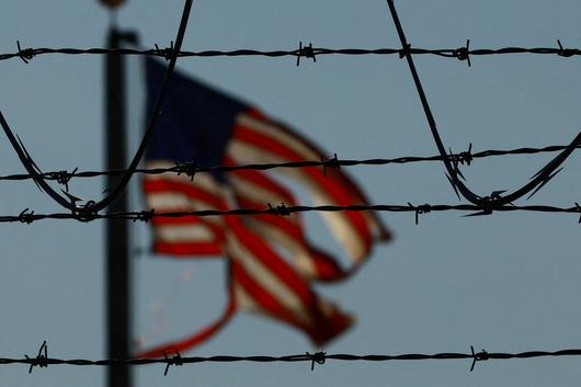 4일(현지시간) 미국 이민국은 망명 신청자 및 합법적 임시 체류자가 미국에 잠정적으로 체류하며 일할 수 있도록 하는 공식 고용 허가증의 유효기간을 기존 최장 5년에서 18개월로 단축한다고 발표했다. 지난해 6월13일 미국 텍사스주 엘패소 공항 인근에 설치된 철조망 너머로 미국 국기가 펄럭이고 있다. 로이터연합뉴스