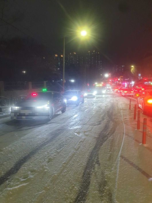 지난 4일 밤 눈이 내려 빙판을 이룬 강원 춘천시 후평동의 한 도로에서 차들이 힘겹게 지나가고 있다. 강원도소방본부 제공