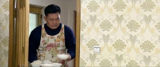 조선중앙TV 드라마 ‘백학벌의 새봄’ 속 남성이 꽃무늬 앞치마를 입고 아내와 딸에게 밥을 차려주고 있다. 조선중앙TV 캡처, 연합뉴스