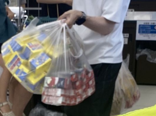 일본맥도날드 매장에서  포켓몬 카드를 사은품으로 주는 해피밀을 잔뜩 구매한 남성이 양손 가득 해피밀을 들고 이동하는 모습. 엑스 계정 ‘SHOWTA_10’ 캡처