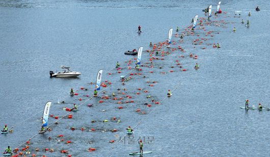 23일 서울 한강 잠실대교 남단 일대에서 열린 2025 한강크로스스위밍챌린지에서 참가자들이 힘껏 헤엄치고 있다. 2025.8.23 오장환 기자