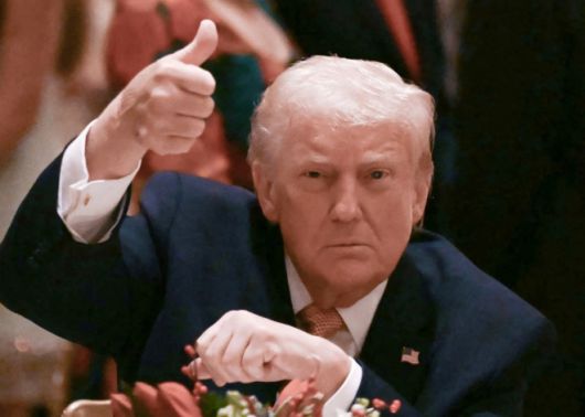 도널드 트럼프 미국 대통령이 24일(현지시간) 플로리다 팜비치의 마러라고 리조트에서 열린 성탄절 만찬에 참석해 엄지를 치켜들고 있다. AFP 연합뉴스
