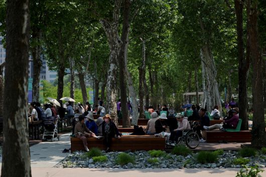 관람객들이 동행정원과 작가정원 사이 나무 그늘에서 쉬고 있다.