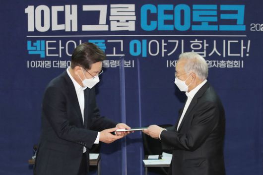 이재명 더불어민주당 대선 후보가 12일 오후 서울 마포구 경총회관에서 열린 10대 그룹 CEO 토크 '넥타이 풀고 이야기합시다'에 참석해 손경식 한국경영자총협회 회장에게 정책건의서를 전달받고 있다./사진=뉴스1