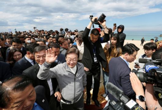 [강릉=뉴시스] 조성우 기자 = 민심을 청취하는 '경청 투어'에 나선 이재명 더불어민주당 대선후보가 3일 강원도 강릉시 안목해변 카페거리를 걸으며 주민들과 관광객들에게 인사하고 있다. 2025.05.03. xconfind@newsis.com /사진=조성우