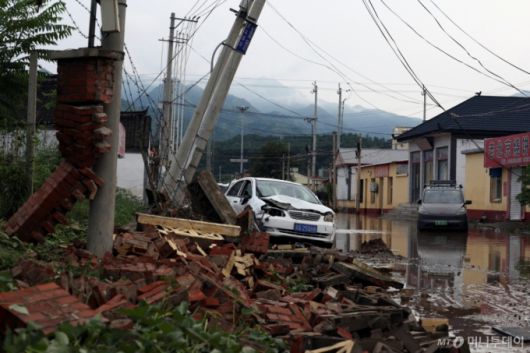 (로이터=뉴스1) 중국 베이징 미윈구에서 폭우로 인해 지역이 침수되면서 파손된 차량과 잔해가 쌓여있다. 2025.7.28  ⓒ 로이터=뉴스1  Copyright (C) 뉴스1. All rights reserved. 무단 전재 및 재배포,  AI학습 이용 금지.