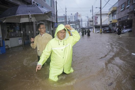강기정 광주시장이 하루 동안 역대 가장 많은 비가 쏟아진 17일 오후 폭우로 침수된 북구 신안교 일대를 돌며 피해상황을 점검하고 있다. /광주시