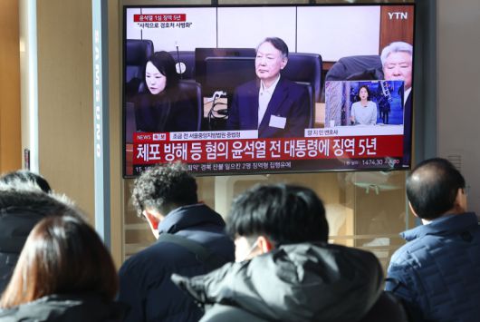 16일 서울역 대합실에서 시민들이 고위공직자범죄수사처(공수처) 체포 방해 등 혐의로 기소된 윤석열 전 대통령에 대한 1심 선고 공판 생중계를 보고 있다. 연합뉴스