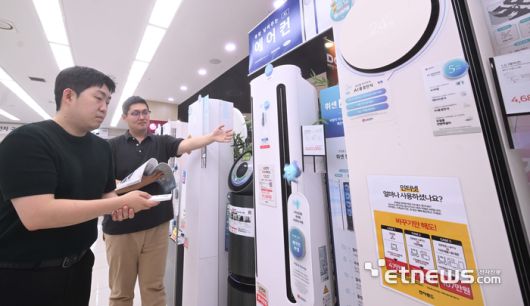 역대급 무더위가 계속되고, 1등급 전자제품 대상 환급제도를 이용하는 고객이 증가하면서 냉방제품 수요가 증가했다. 가전양판점에서는 7월 초중순 냉방제품 판매량이 지난해 대비 에어컨은 2~3배 이상, 선풍기는 1.5배 이상 상승한 것으로 나타났다. 주말 서울 용산 전자랜드에서 고객이 에어컨을 살펴보고 있다.  박지호기자 jihopress@etnews.com