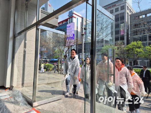 이준석 개혁신당 대선 후보 등 지도부가 10일 서울 강남역 인근 1층에 마련된 선거 사무실의 벽을 당의 상징인 '오렌지'색으로 칠하기 위해 들어오고 있다. [사진=김주훈 기자]