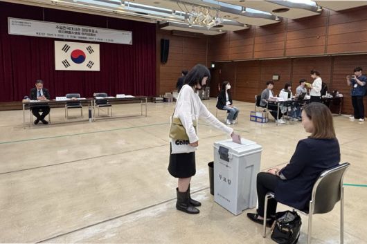 제21대 대통령 선거 재외투표 첫날인 20일 일본 도쿄 미나토구 주일한국대사관에 마련된 재외투표소에서 유권자가 투표함에 투표용지를 넣고 있다. 연합뉴스