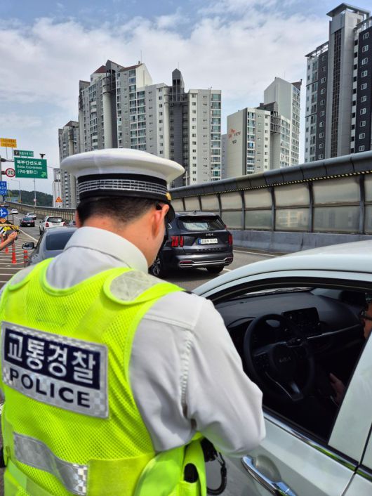 내부순환로 성수 방면 북부간선로 분기점에서 운전 중 휴대폰 사용으로 적발된 운전자가 경찰 단속을 받고 있다. 사진=공동취재단