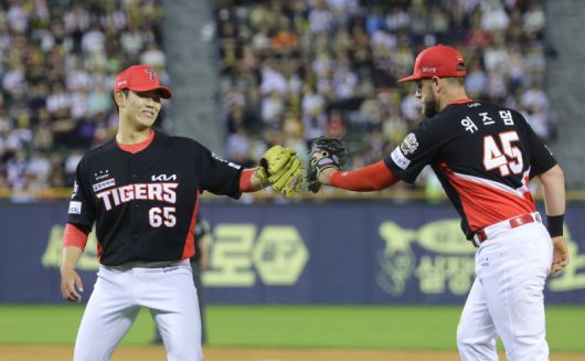 KIA 1루수 위즈덤이 아웃시키자 투수 성영탁(왼쪽)이 서로 글러브를 맞대고 기뻐하고 있다. 뉴시스