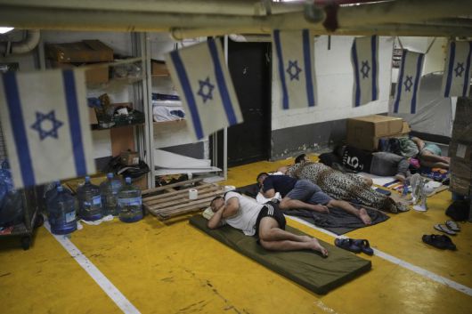 24일(현지시간) 이스라엘 텔아비브의 지하 주차장에서 이란의 미사일 공격을 피해 도망친 난민들이 잠을 청하고 있다.AP뉴시스