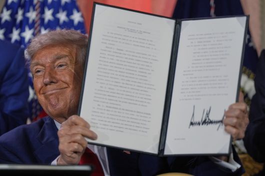 도널드 트럼프 미국 대통령이 지난달 23일(현지 시간) 워싱턴의 앤드루 W. 멜론 강당에서 열린 AI 정상회의에 참석해 연설한 뒤 서명한 AI 관련 행정명령을 들어 보이고 있다. AP뉴시스