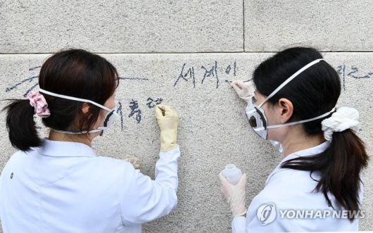 지난 11일 국가유산청 국립고궁박물관 관계자들이 낙서로 훼손된 서울 종로구 경복궁 광화문 석축의 긴급 복구 작업을 진행하고 있다. 국가유산청 제공. 연합뉴스