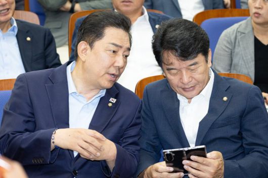 김병기 더불어민주당 원내대표(왼쪽)와 문진석 원내운영수석부대표가 24일 서울 여의도 국회에서 열린 의원총회에서 대화하고 있다. 뉴스1