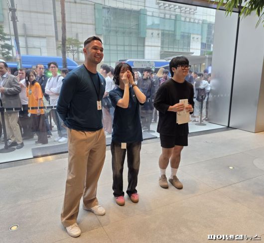 19일 오전 서울 중구 애플스토어 명동에서 직원들이 첫 구매자 김지민씨(오른쪽)를 축하해주고 있다. 사진=박성현 기자