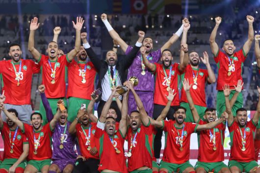 모로코 선수들이 18일(현지 시간) 카타르 루사일 스타디움에서 열린 2025 국제축구연맹(FIFA) 아랍컵 정상에 올라 트로피를 들고 환호하고 있다. 모로코는 결승에서 요르단과 연장 끝 3-2로 역전승을 거두고 우승을 차지했다.뉴시스