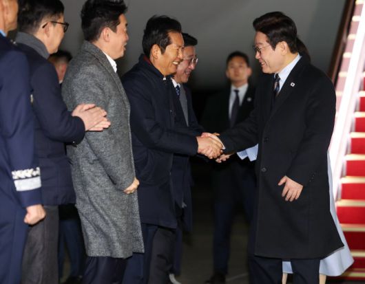 중국 국빈 방문 일정을 마치고 귀국한 이재명 대통령이 7일 경기 성남 서울공항에서 환영나온 더불어민주당 정청래 대표와 인사하고 있다. 연합뉴스