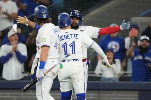 Toronto Blue Jays' Bo Bichette (11) celebrates his three-run home run with Vladimir Guerrero Jr., back, as Addison Barger (47) looks on during the third inning in Game 7 of baseball's World Series against the Los Angeles Dodgers in Toronto on Saturday, Nov. 1, 2025. (Nathan Denette/The Canadian Press via AP) MANDATORY CREDIT        <저작권자(c) 연합뉴스, 무단 전재-재배포, AI 학습 및 활용 금지>