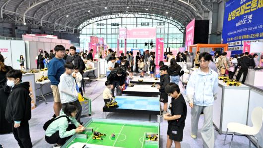 남원종합스포츠타운 컨벤션홀에서 열린 드론·로봇 체험존에서 아이들이 직접 조종하며 '로봇 축구'를 즐기고 있다. [사진=남원시]
