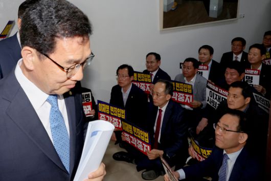 더불어민주당 이재명 대선 후보가 '골목골목 경청투어:국토종주편'에 나선 7일 전북 전주시 풍남문 앞 광장에서 지지자가 든 공판 연기 환영 팻말을 지나고 있다.   이날 서울고등법원은 오는 15일 예정됐던 이 후보의 공직선거법 위반 혐의 사건 파기환송심 첫 공판을 오는 6월 18일로 연기했다. 연합뉴스