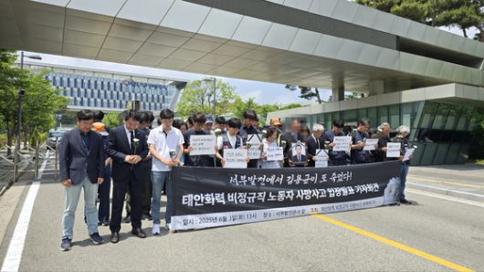 지난 2일 태안화력발전소 정비건물에서 일하다 숨진 고(故) 김충현씨 사망사고와 관련, 유족과 노동자들이 한국서부발전 앞에서 기자회견에 앞서 묵념을 하고 있다. 신진호 기자