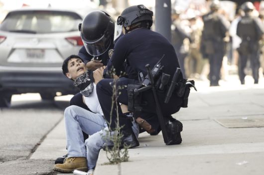현지시간 8일 로스앤젤레스 시내에서 시위대 중 한 명이 체포되고 있다. AP=연합뉴스