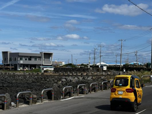 우도 해안도로를 운행 중인 전기 삼륜차. 최충일 기자