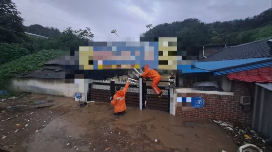 군산시 공무원들이 7일 새벽 기록적인 폭우로 침수 피해를 입은 나운동·문화동 일대에 급파돼 주민과 함께 쓰레기를 치우거나 배수 작업을 돕고 있다. 사진 군산시